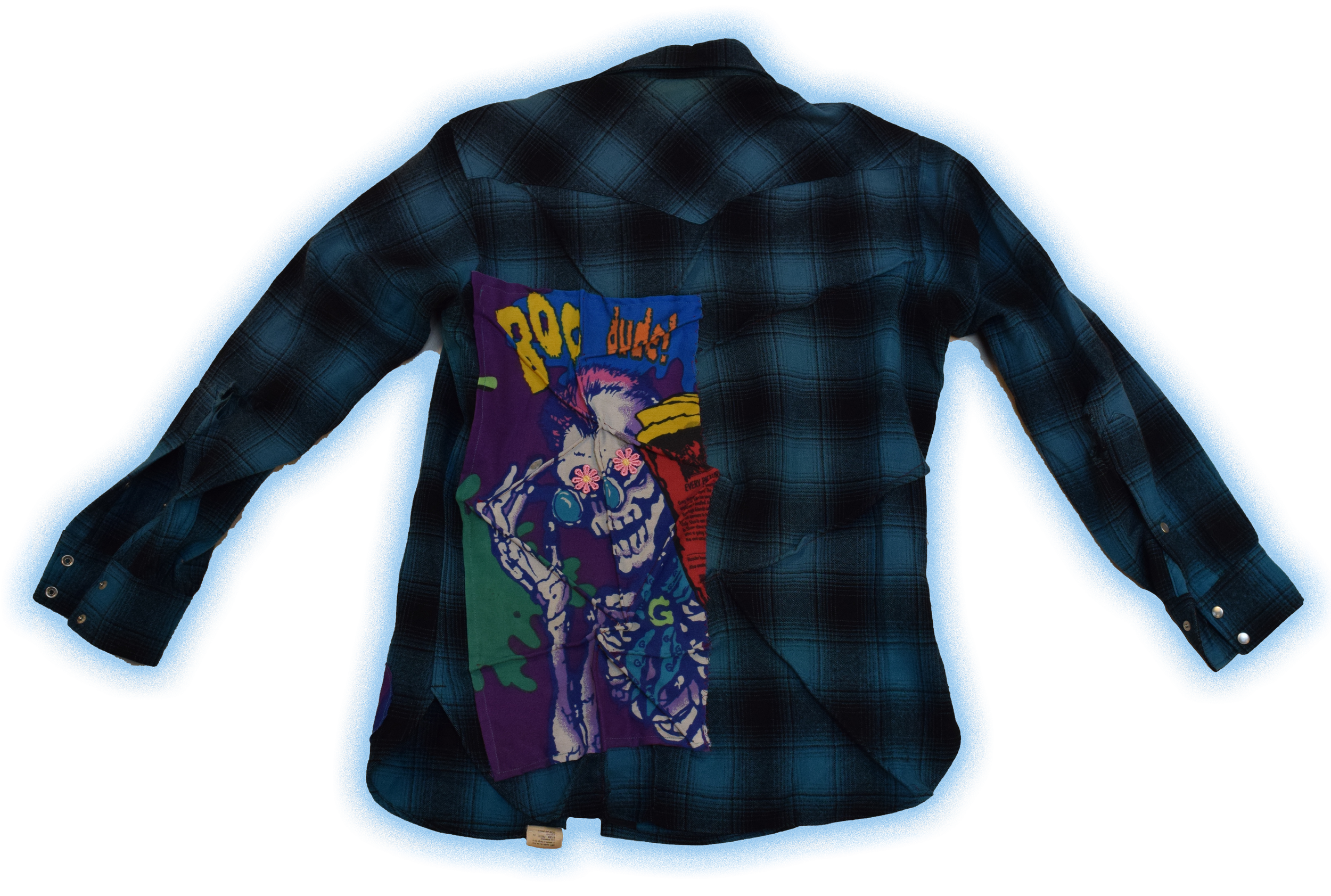 Back of a dark blue plaid shirt with an embroidered fabric patch depicting a colorful skeleton with pink flowers, sunglasses, and a cigarette.