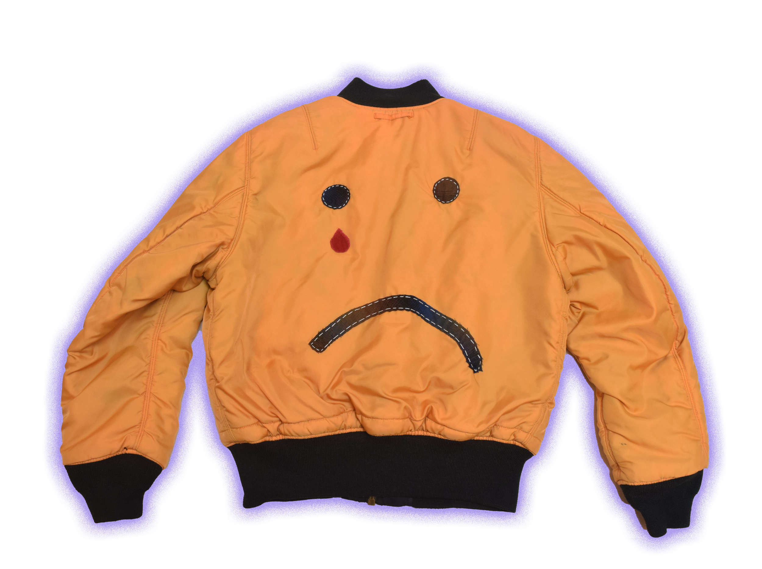 A yellow bomber jacket with black cuffs and collar, featuring a sad face design on the back with two black eyes, a red tear, and a black frowning mouth.