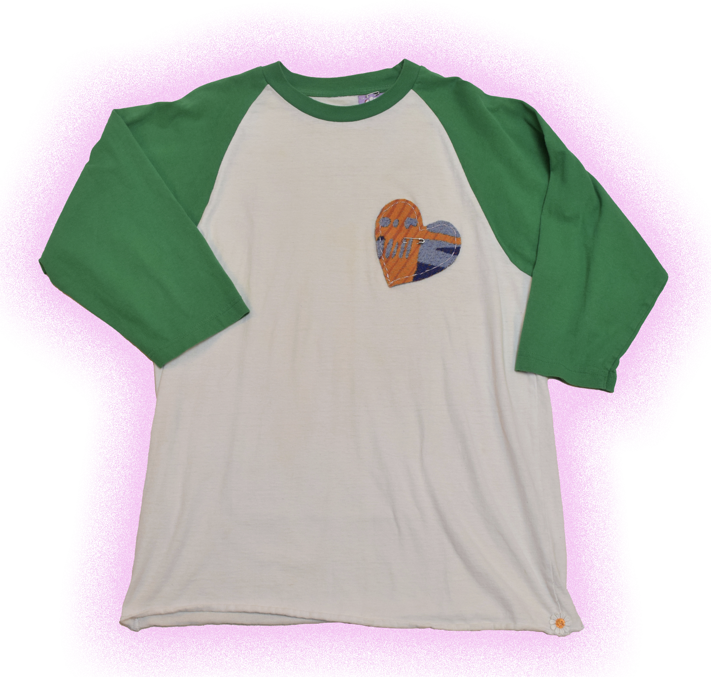 A white and green long sleeve baseball-style shirt with a heart-shaped patch on the front.