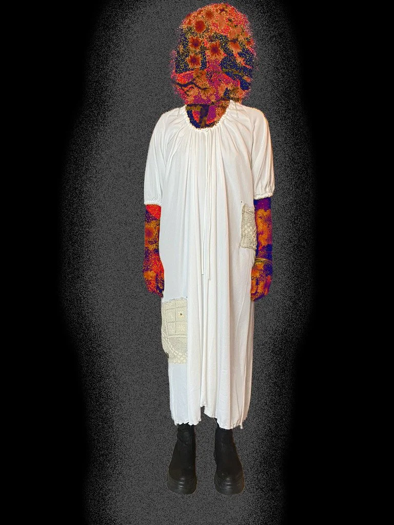 Figure with a floral head and pigmented arms, wearing a white dress and black shoes, standing against a dark background.