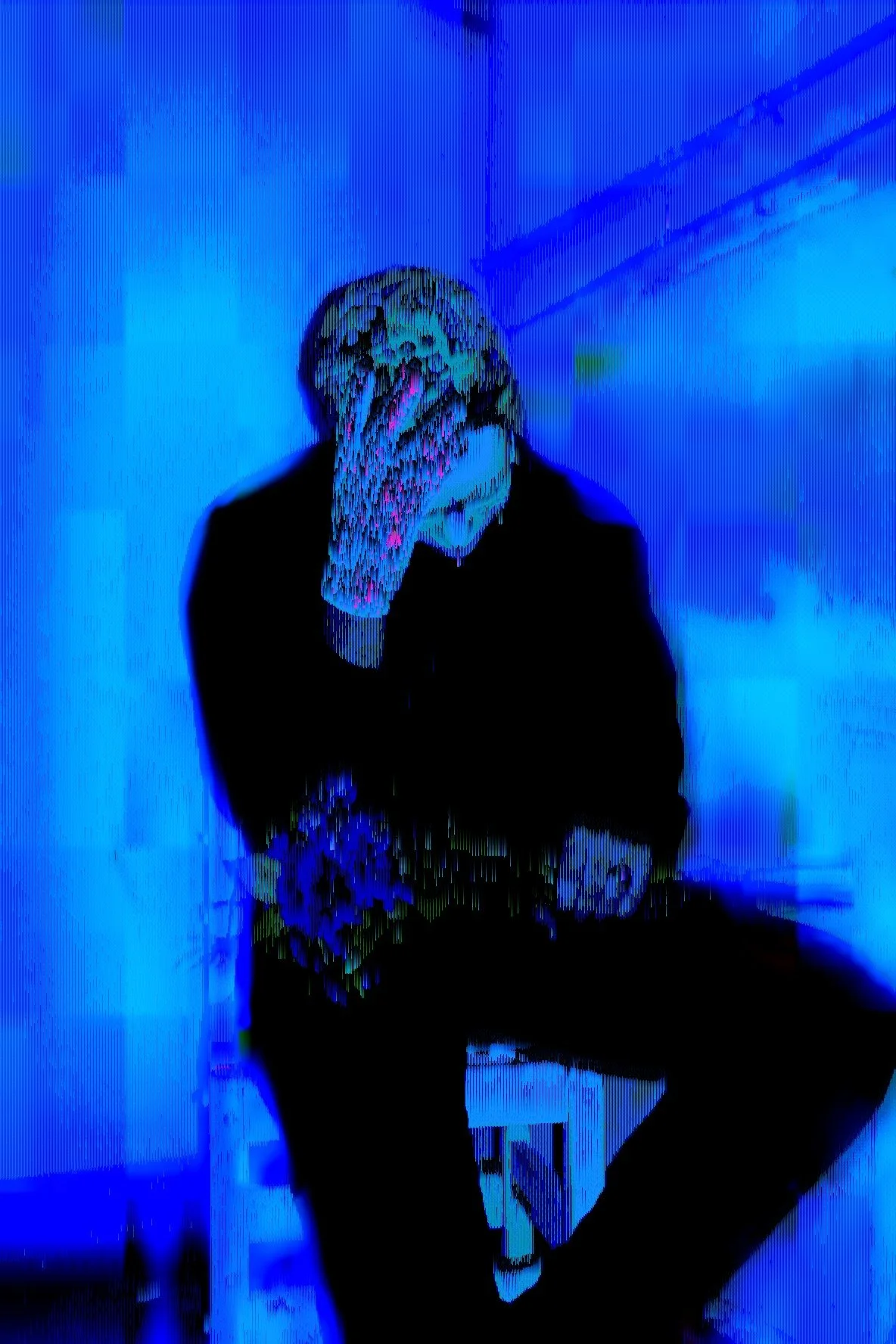 Person sitting with hand covering face, heavily distorted with digital glitch effects, blue and black tones.