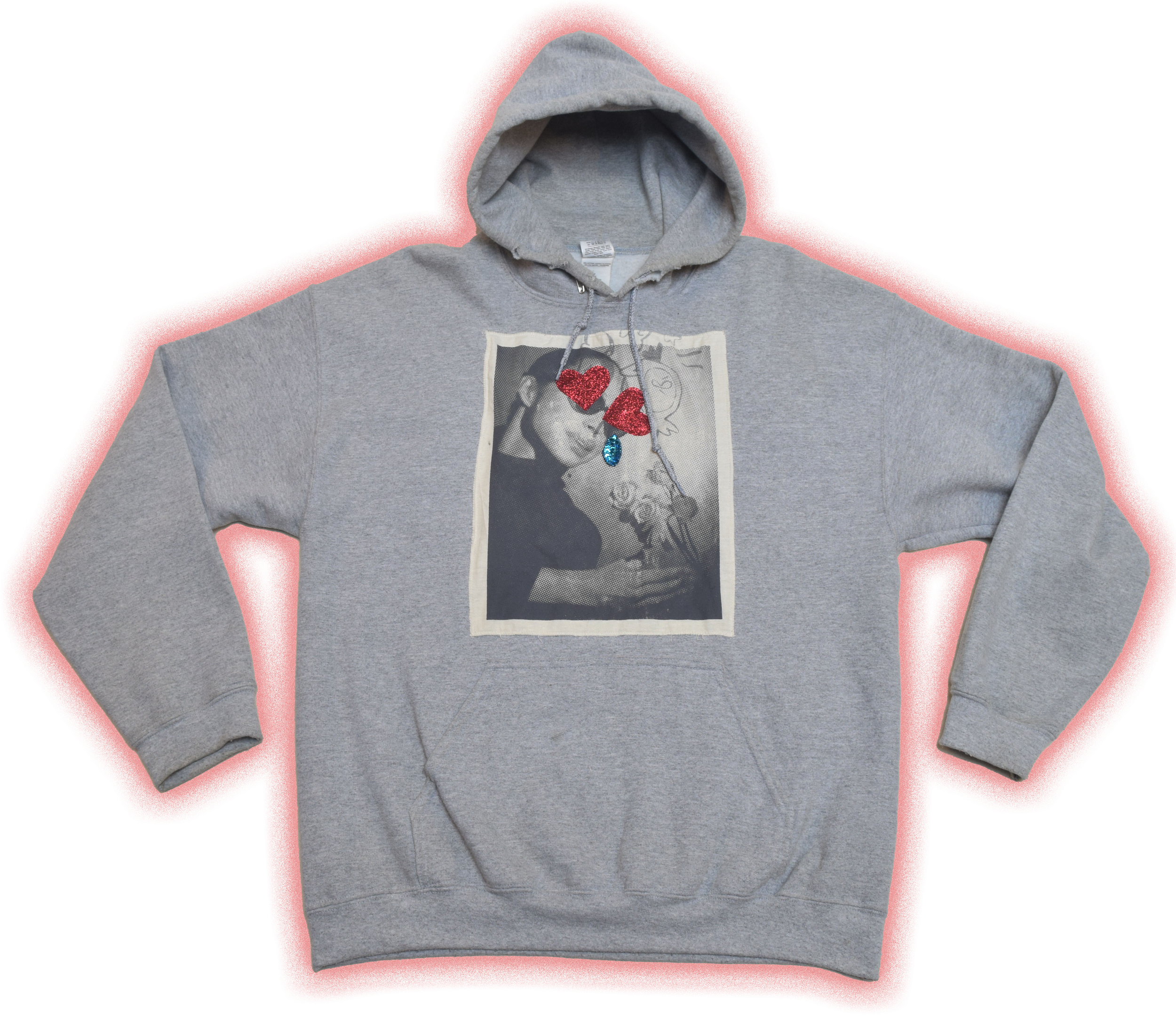 Gray hoodie with a black and white photograph on the front, depicting two people holding a small dog with red glittery hearts and a blue teardrop-shaped accessory on the photograph.
