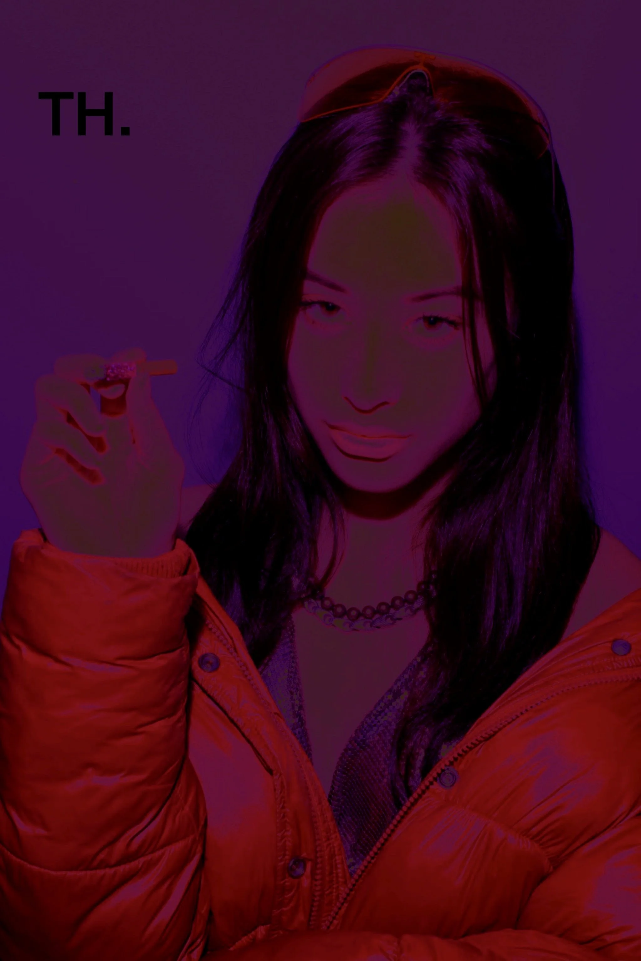 A woman with dark hair, wearing a red puffer jacket, sunglasses on her head, and a chain necklace, is holding a cigarette or joint and making a playful face. The image has a neon, colorful lighting effect.