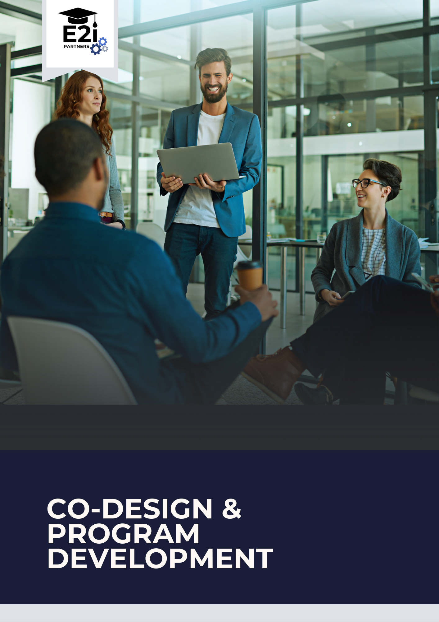 People in a business meeting in a modern office, with one man standing and holding a laptop, others seated and listening, with a logo in the corner that reads 'E2i Partners'.