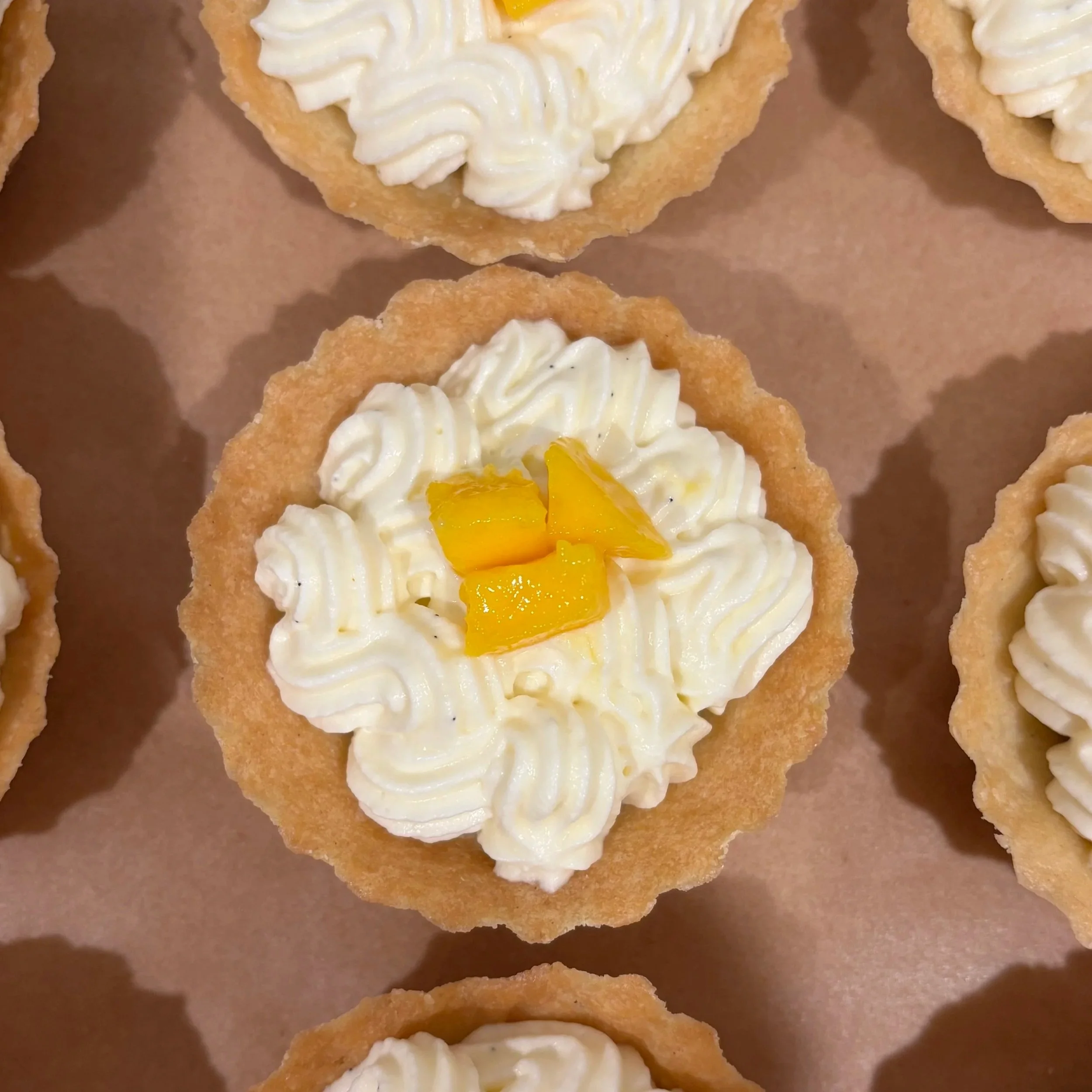 Mini mango curd and vanilla cream tart