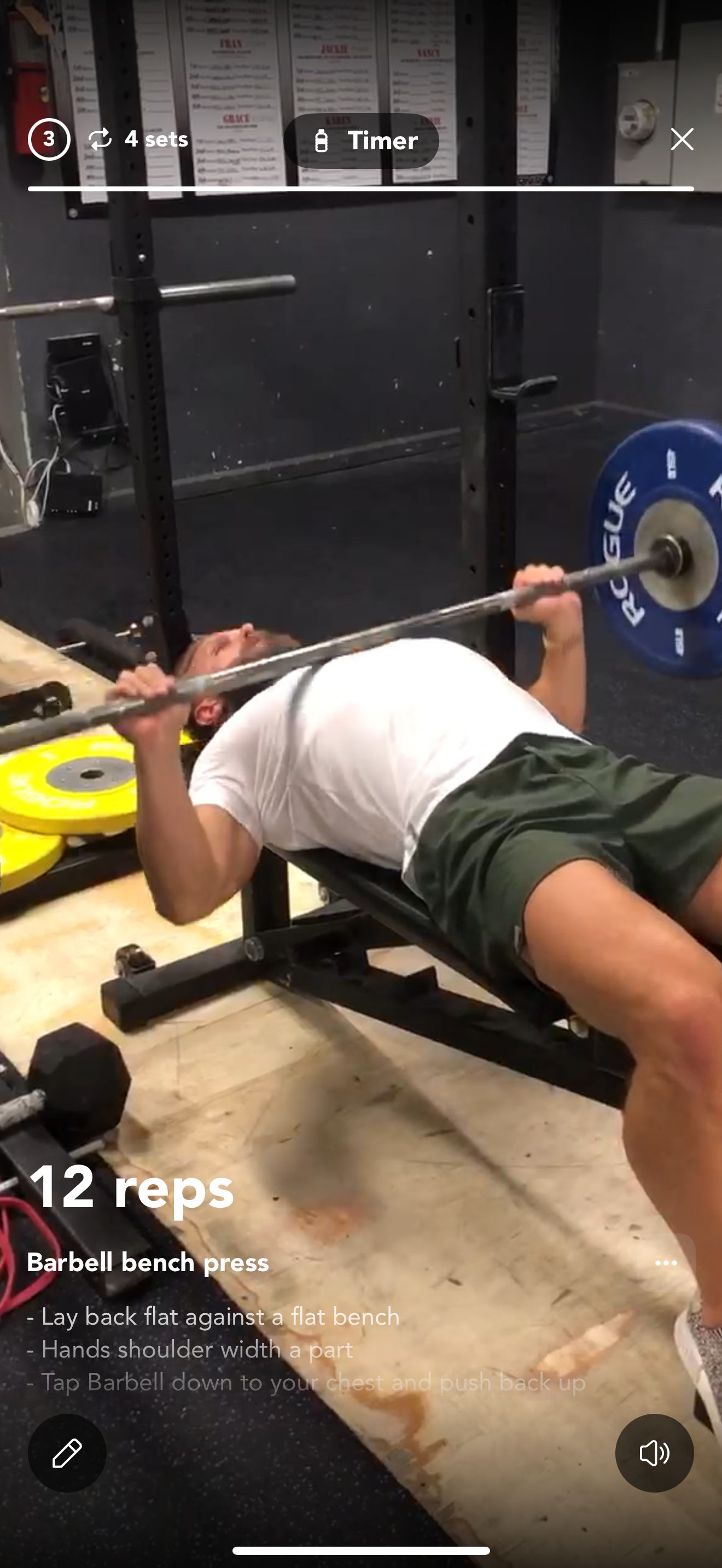 Man performing resistance band exercise in gym with dumbbells and plants