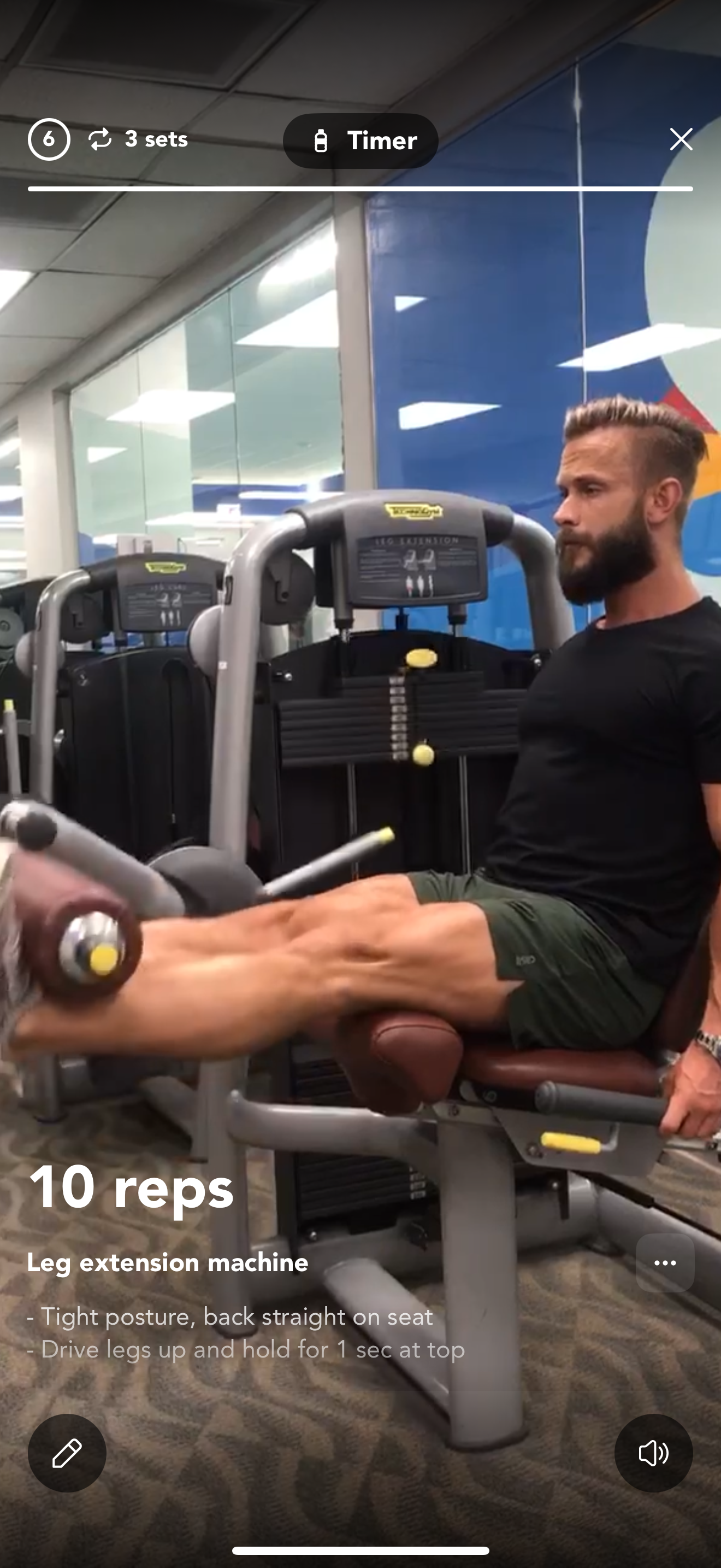 Man exercising with resistance band in gym, extending arms outward; dumbbells and fitness equipment in background.