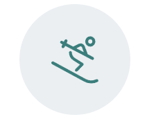 Icon of a person skiing downhill inside a circle