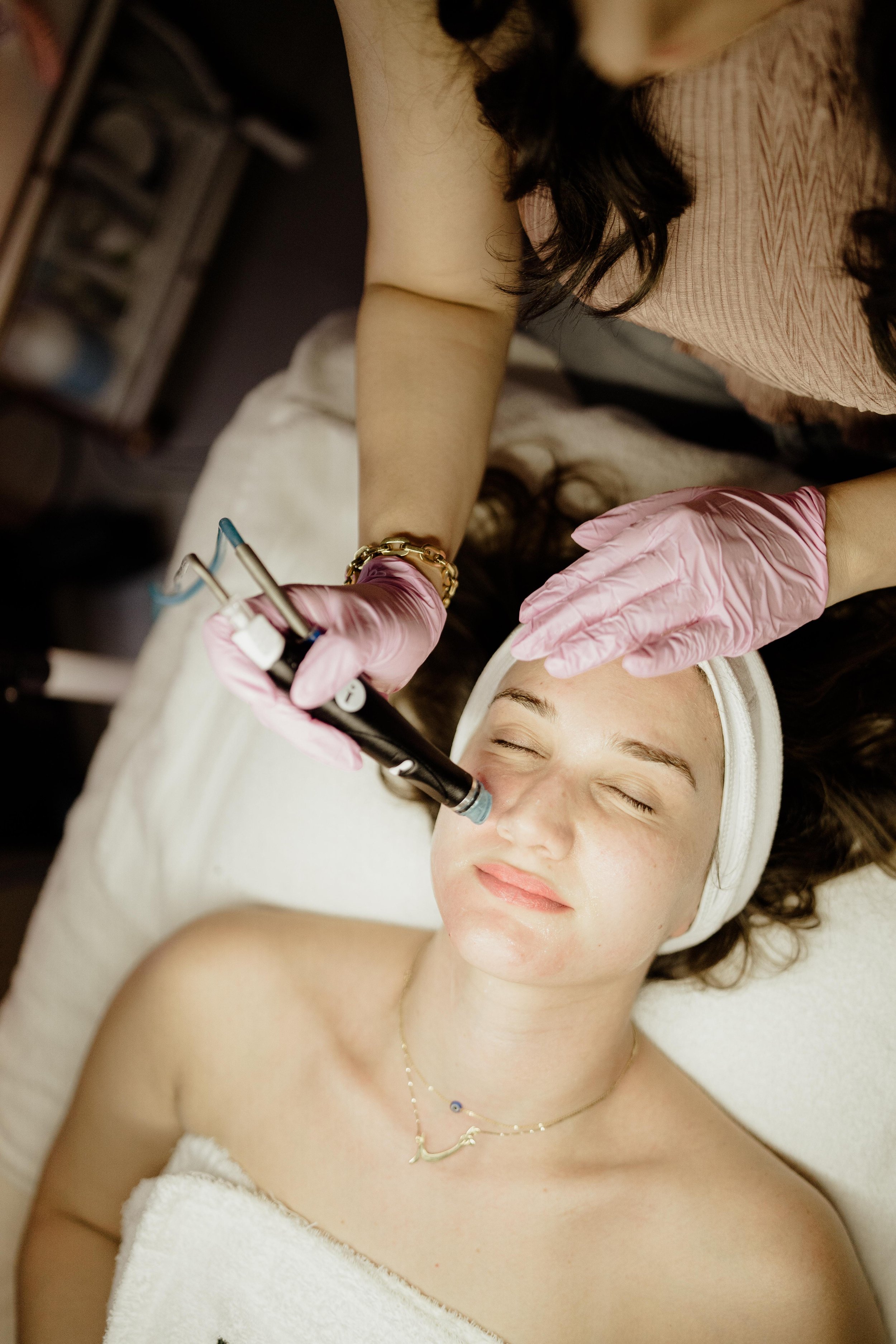 Esthetician performing a membership facial at Skin Fairy Aesthetics