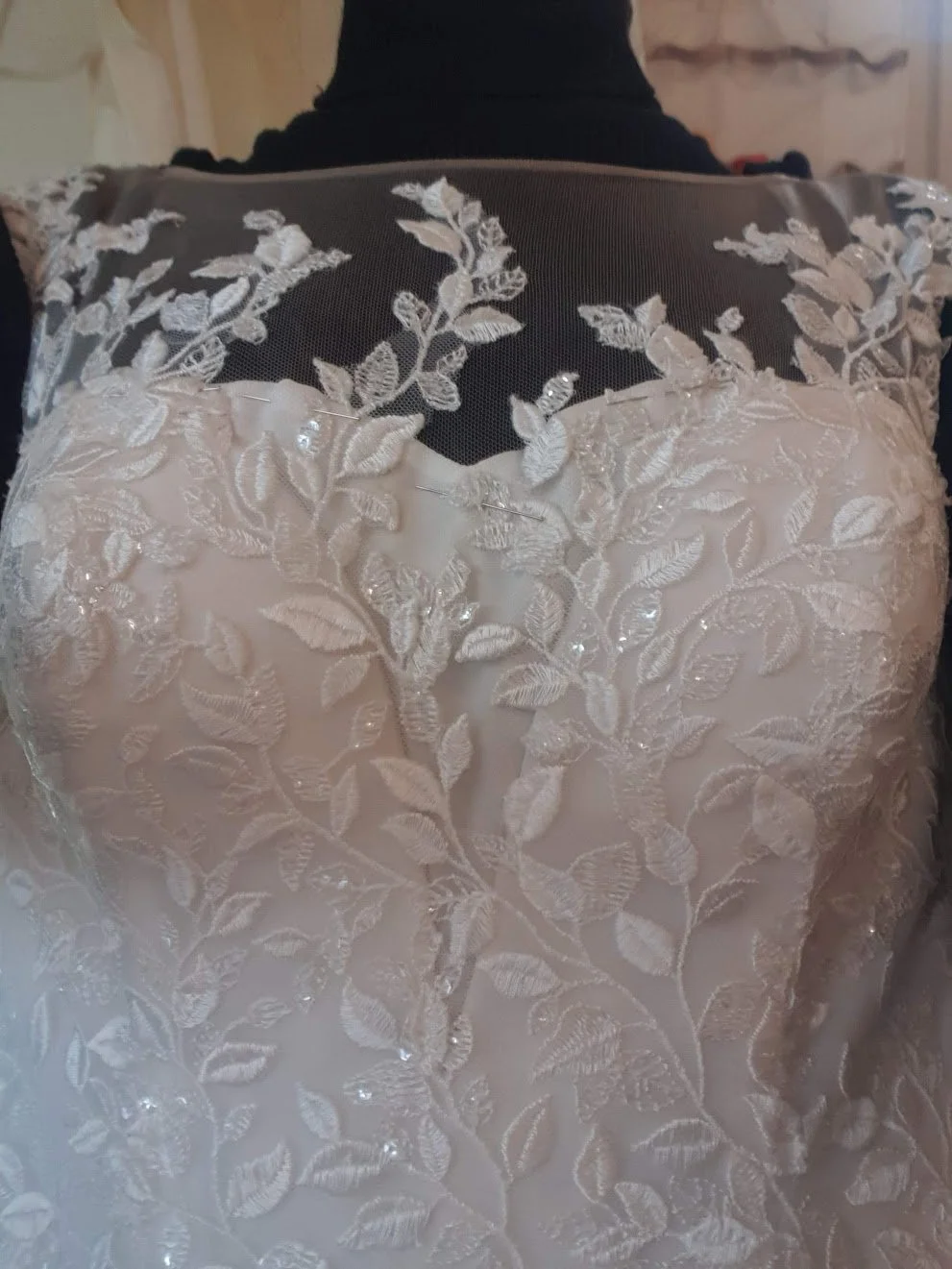 A custom modesty panel seamlessly extending a sweetheart neckline, crafted with matching fabric and delicate details for a refined, elegant look. Perfect for personalized bridal gown alterations.