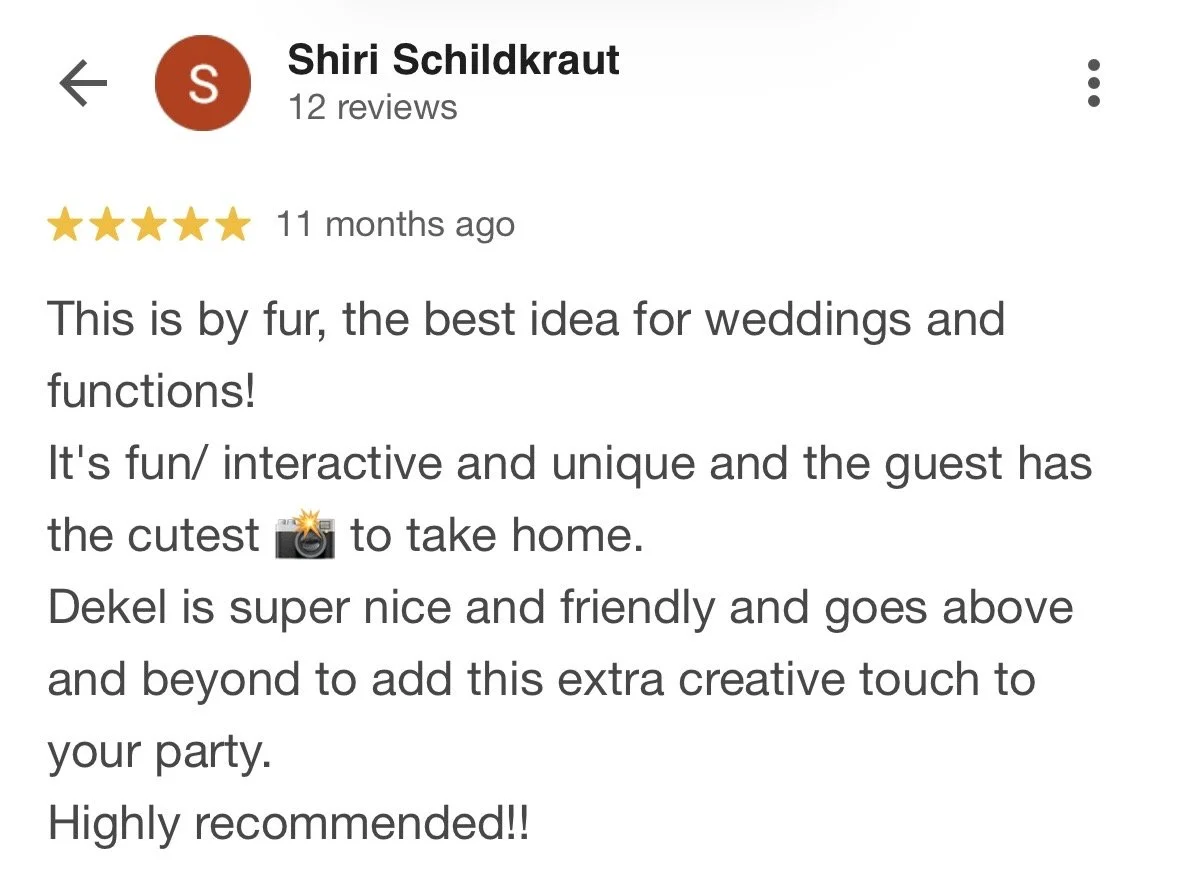 Customer review for an interactive photo booth at a wedding or event, mentioning a friendly host named Dekel and the guest's ability to take photos. The review highlights the booth's fun, interactive nature and includes a camera emoji.