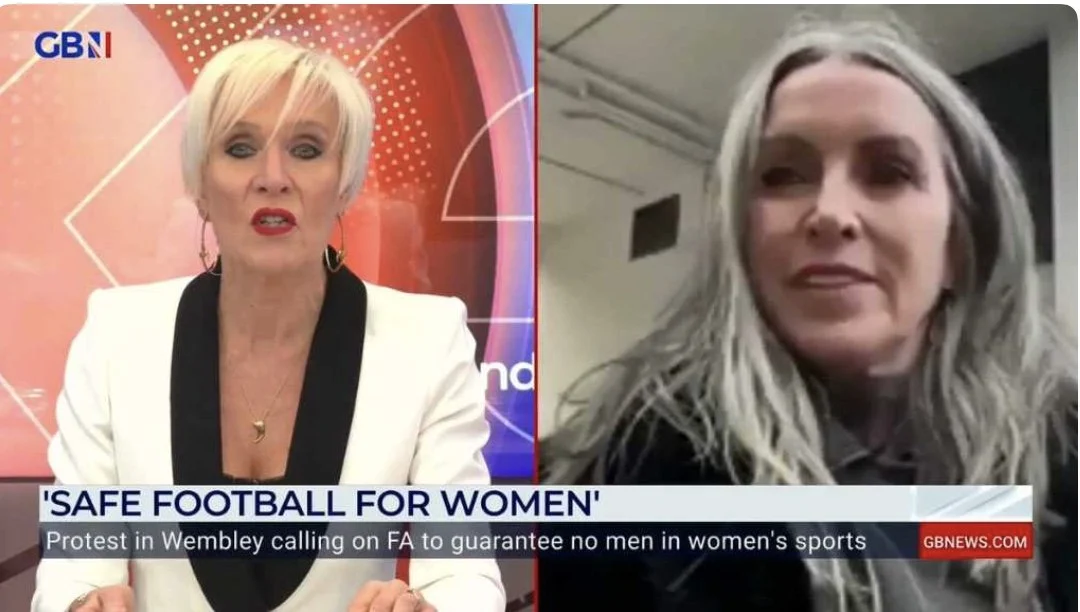 TV news segment with anchor in white blazer on left and guest on right, discussing 'Safe Football for Women', with protest in Wembley against men in women's sports.