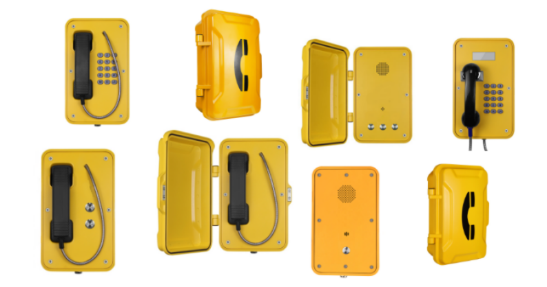 Multiple yellow emergency weatherproof, robust phones with black telephones and buttons, some with open covers showing interior components.
