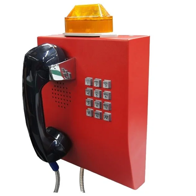 Red emergency telephone box with a black rotary-style phone, keypad, and a yellow flashing light on top.