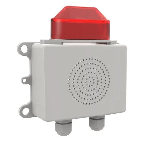 A white emergency alarm box with a red cover and two gray conduit fittings at the bottom.