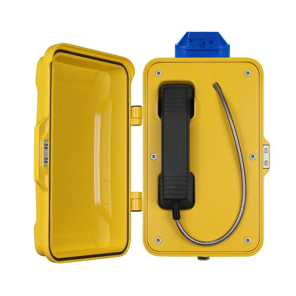 Yellow emergency telephone box with a black handset, a blue light on top, and a metal cable for travel & transport