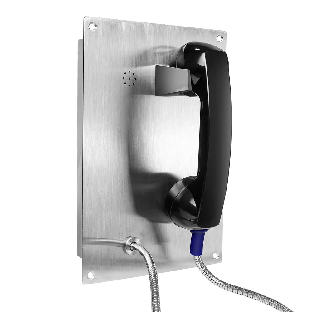 A wall-mounted communication device with a black phone handset attached to a metal plate, with a cord going into the plate.