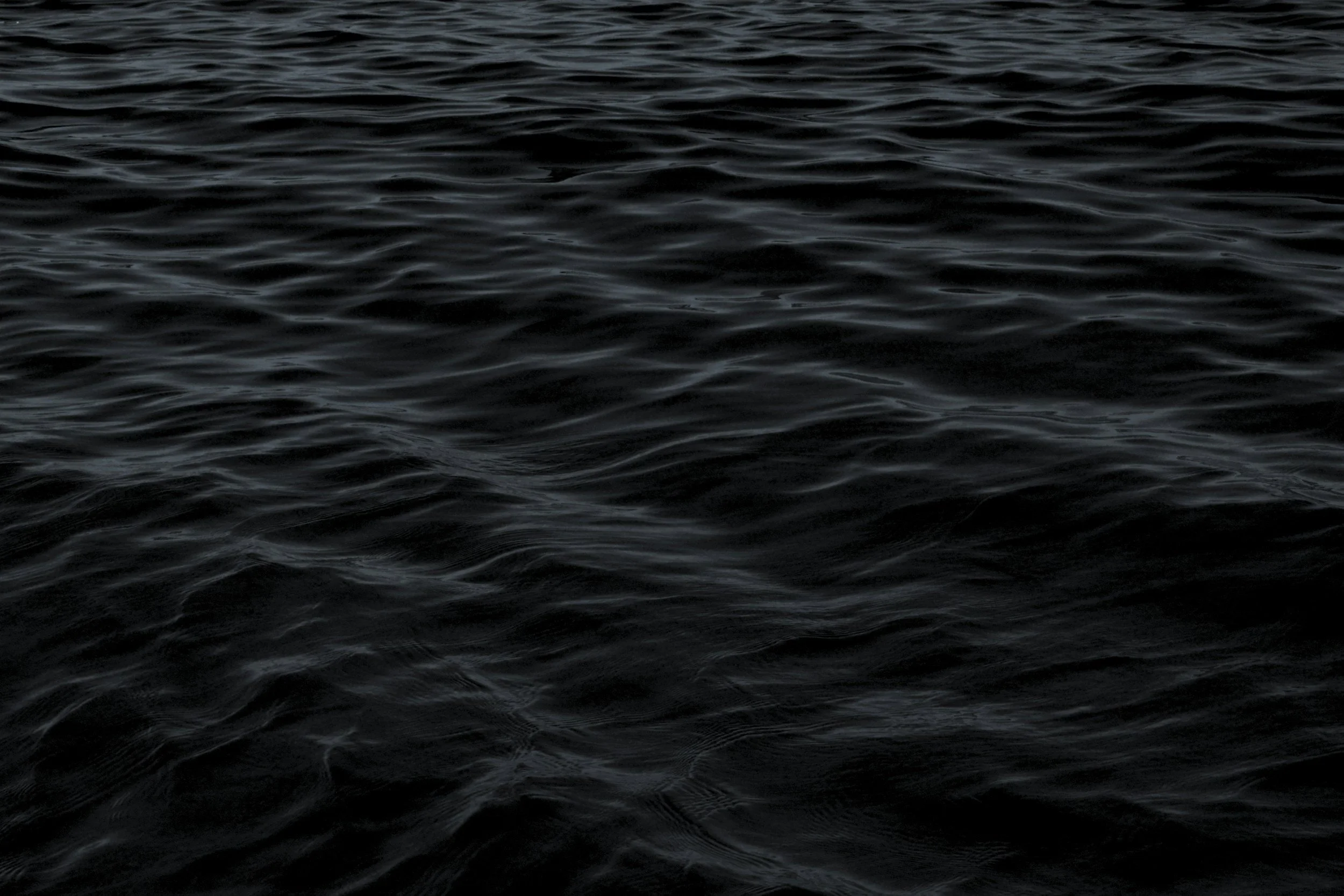 Dark ocean water with gentle ripples and waves