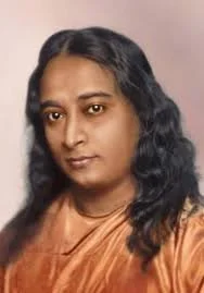 Paramahansa Yogananda with dark wavy hair wearing a brown top, looking at the camera with a neutral expression.