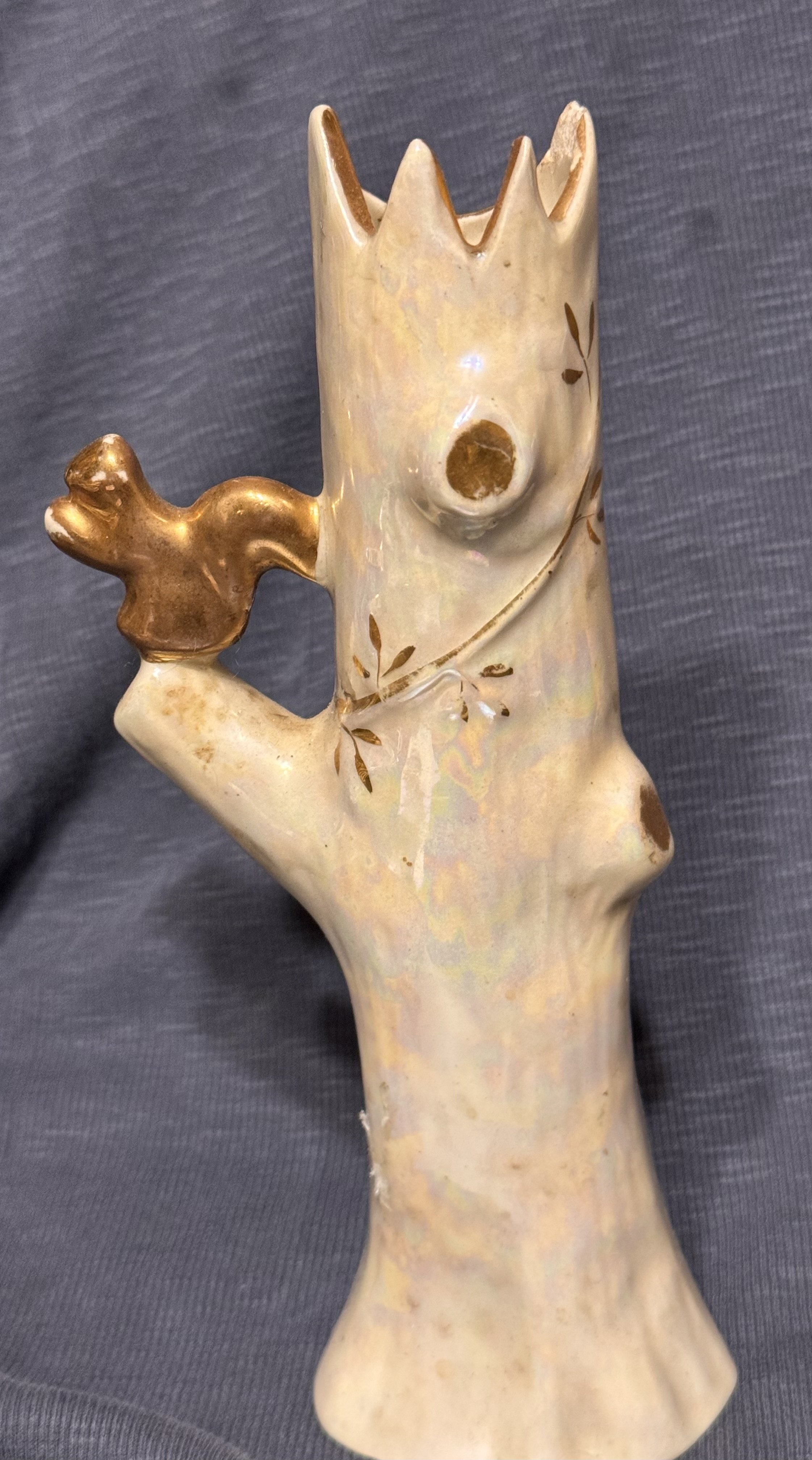 Lusterware squirrel on tree trunk