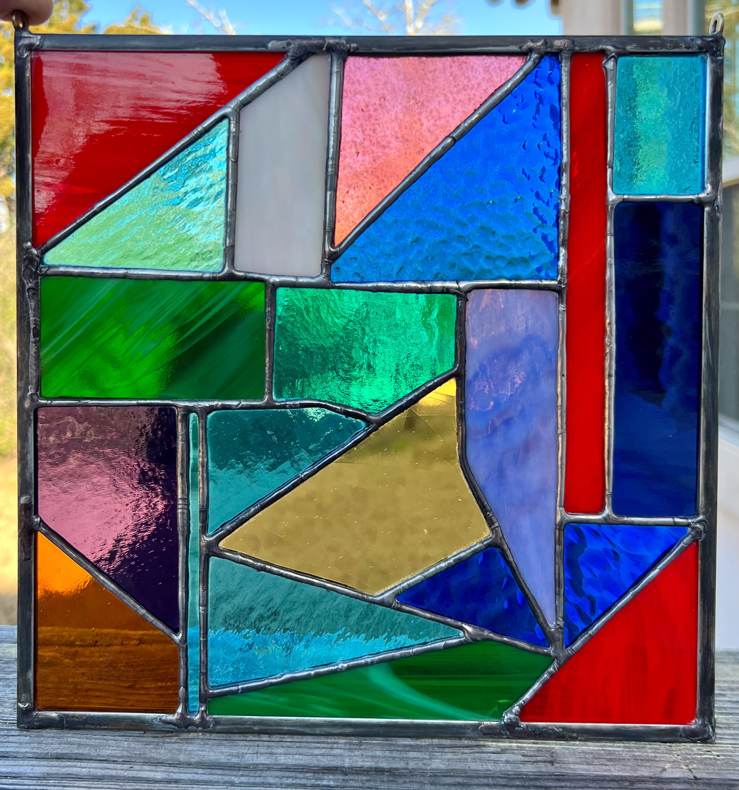 This whimsical piece started as an effort to use previously cut scraps of glass to make an 8" x 8" square. I only made a handful of minor cuts to make it all fit. a few days after it was finished, I noticed that I can see the abstract shapes of a h