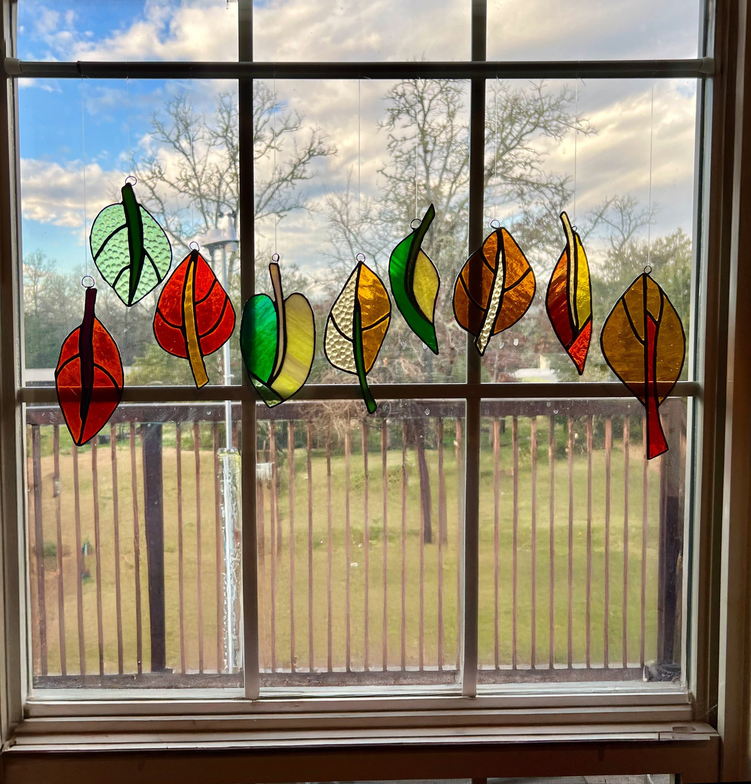 I began making these brightly colored leaves with scrap glass mostly to practice my copper foiling skills. I enjoyed the freedom of doing them with no pattern, each one spontaneous and unique in both shape and color. I loved them so much that they