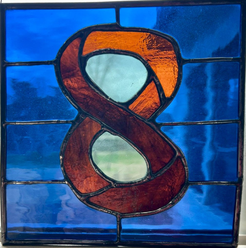 "Ocho" was created in honor of my bilingual grandson who caused quite a commotion when he was born eight days early! The colors were chosen because Ochito has brown eyes with a blue corneal ring.