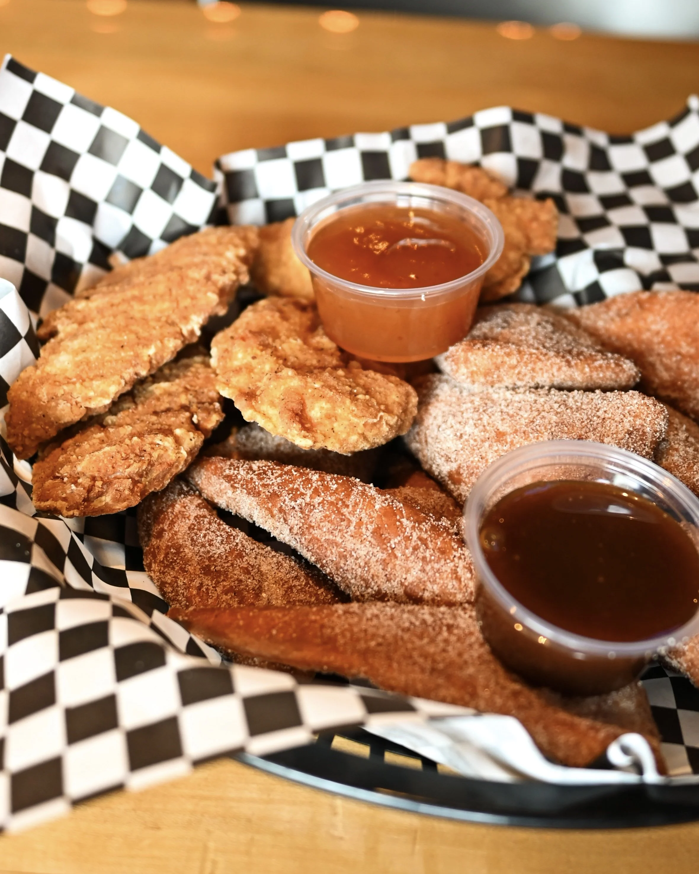 "The Steph" an off-menu dish at The Tilted Turret Pinball Pub consisting of chicken tenders, plum sauce, and "flippers," the pub's deep-fried dough creation dusted in cinnamon sugar, along with caramel sauce.