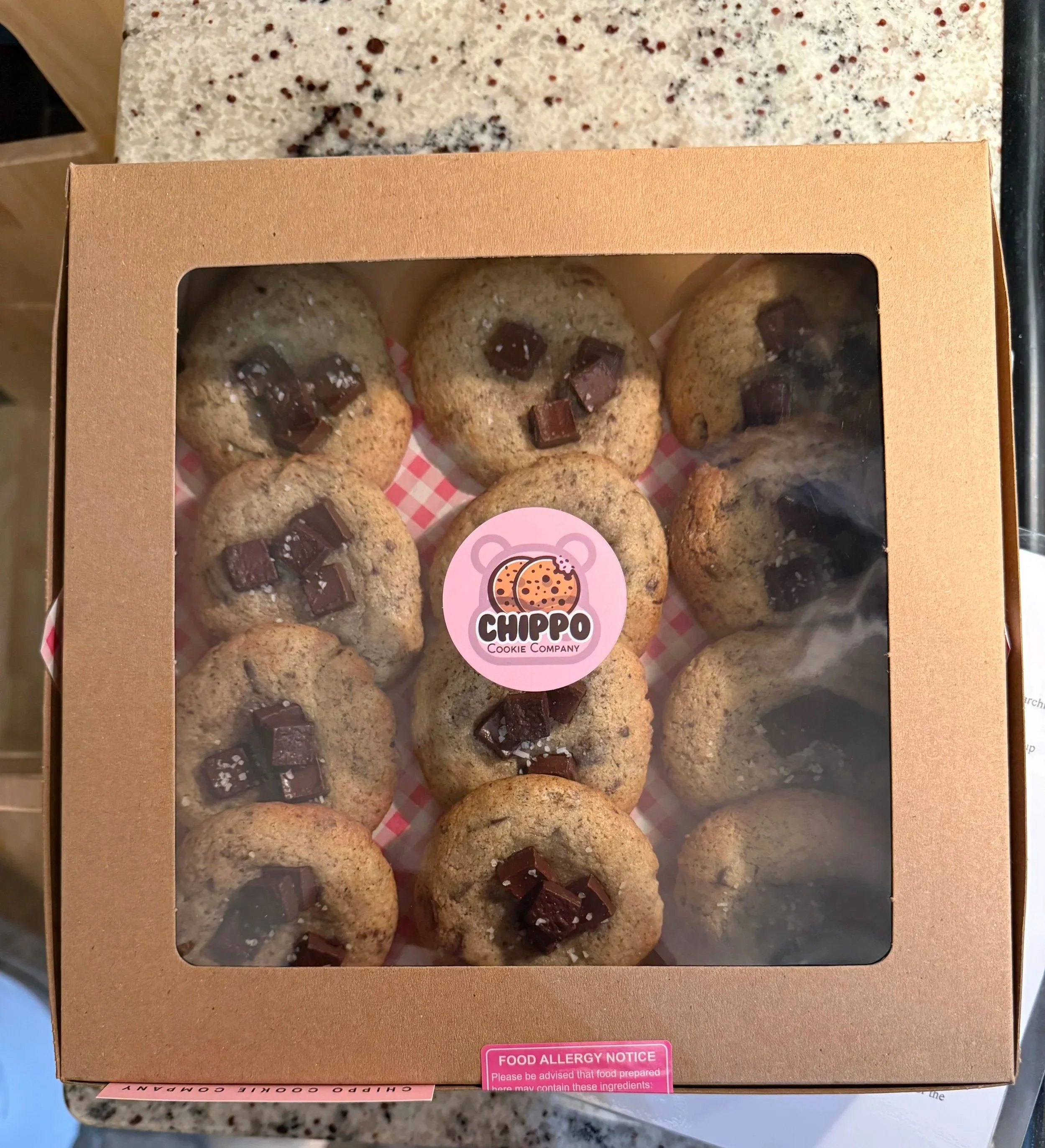 A box of salty buckwheat chocolate chunk cookies from Chippo Cookie Company in Thunder Bay sitting on top of a counter