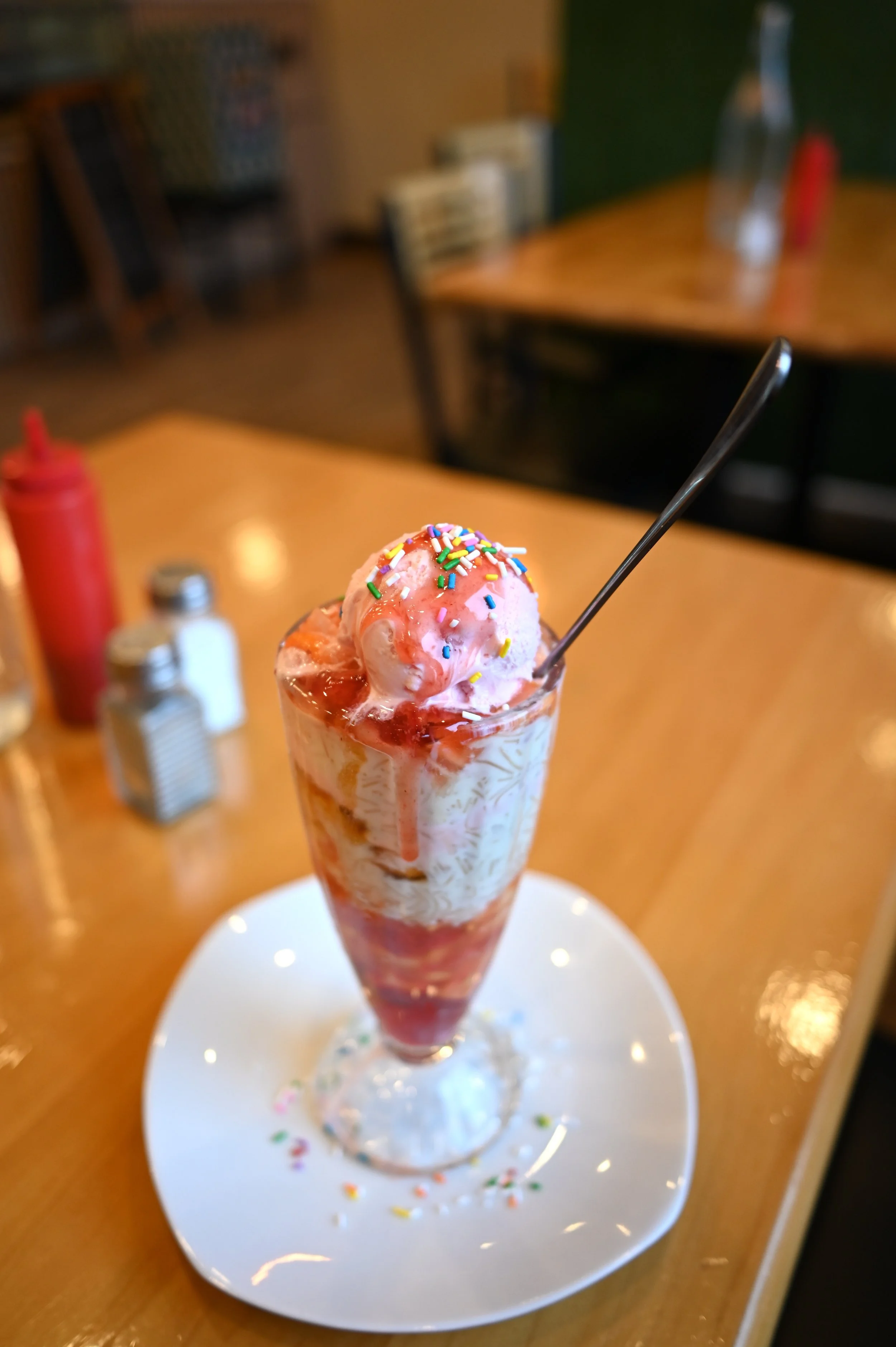 Thekkini's falooda, a whimsical sundae is served with an abundance of fruit, vermicelli noodles, syrup, and jelly, topped with a scoop of strawberry ice-cream and sprinkles