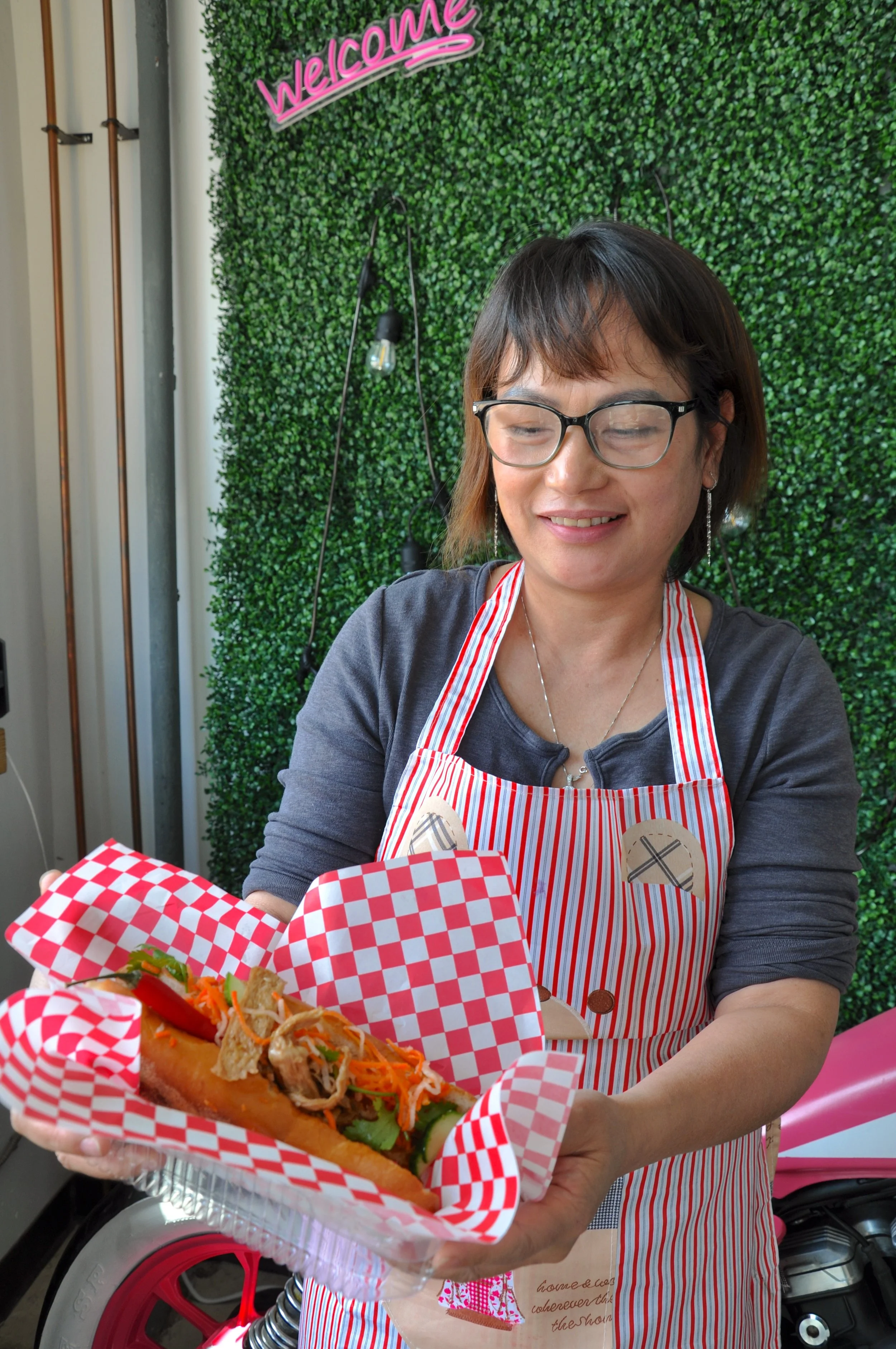 Phuong (Julie) Pham, owner of Slurp It restaurant in Thunder Bay, holding a banh mi sandwich