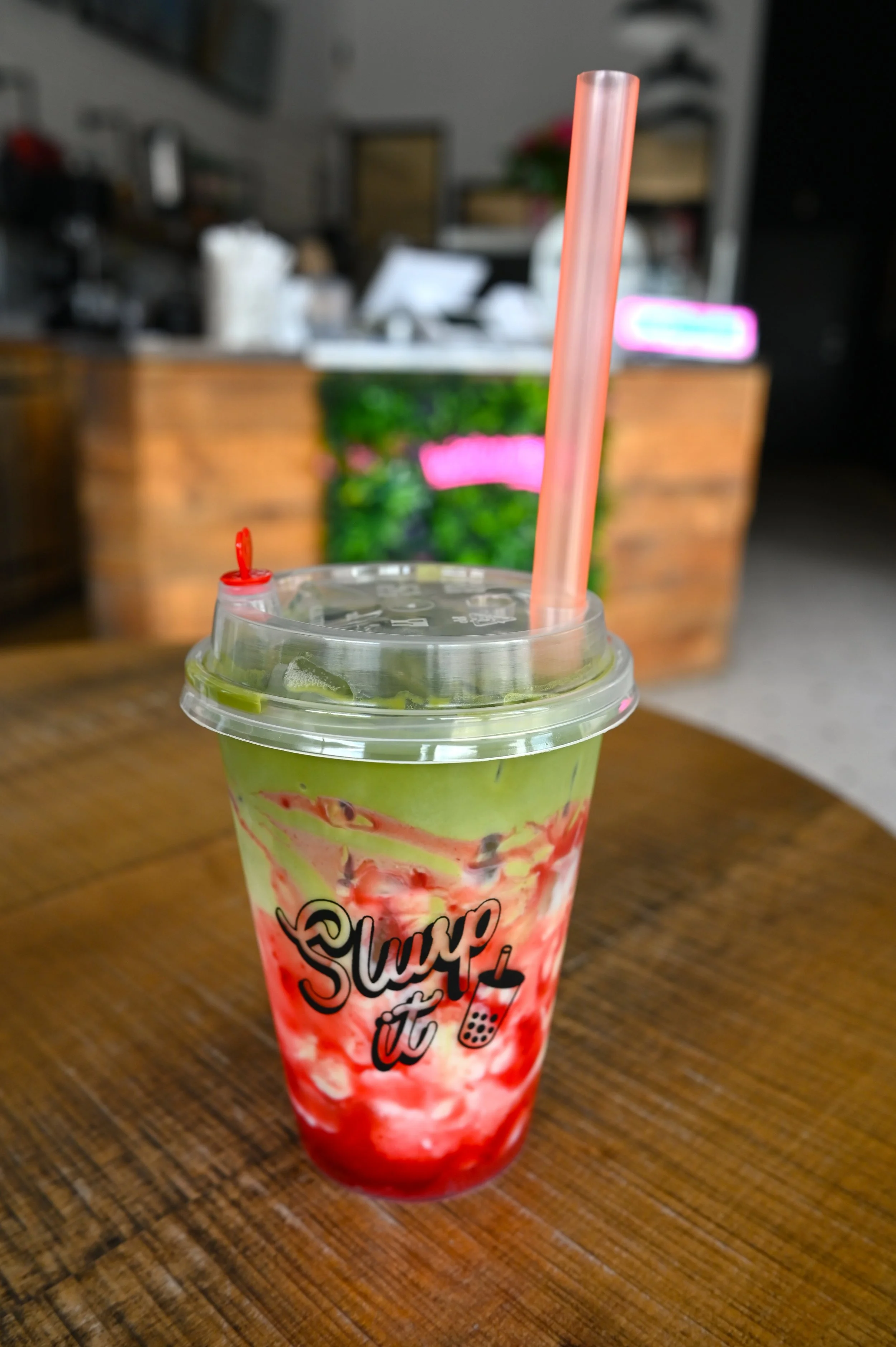 Slurp It's strawberry iced matcha, with vibrant green tea on top mixed with strawberry syrup