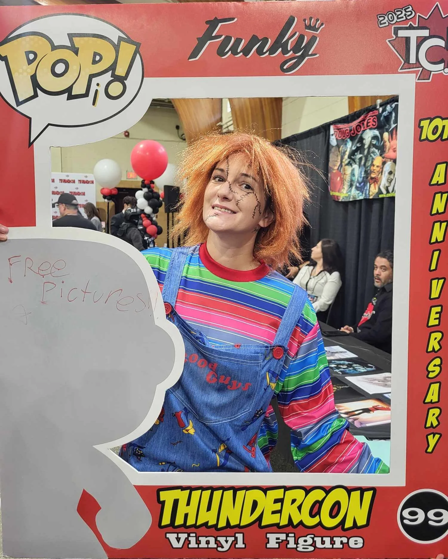 A ThunderCon attendee dressed as Chucky posed behind a cardboard cut-out picture frame at a previous convention