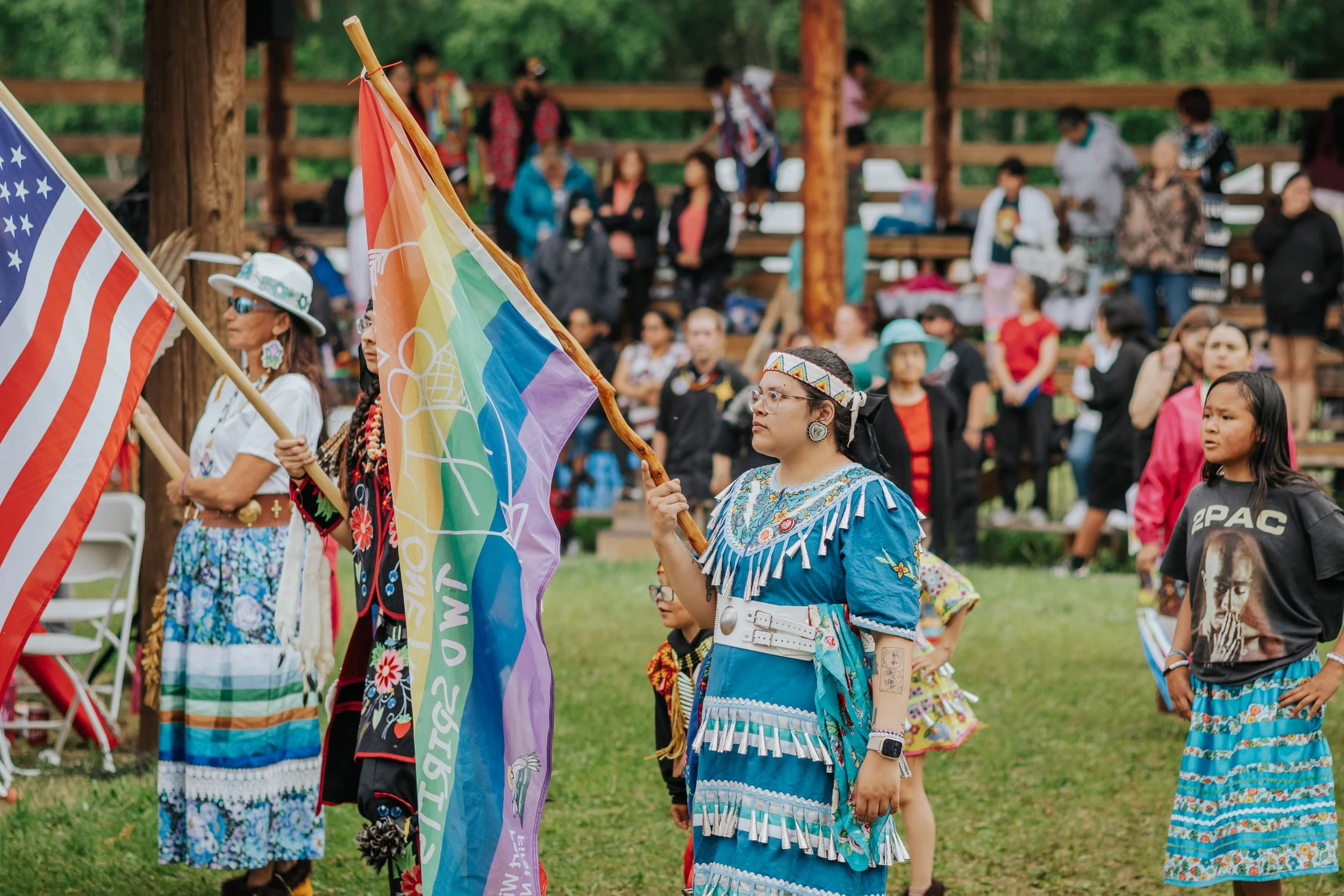 People dressed in regalia and holding flags at the 2026 National Indigenous Peoples Day celebrations on Fort William First Nation
