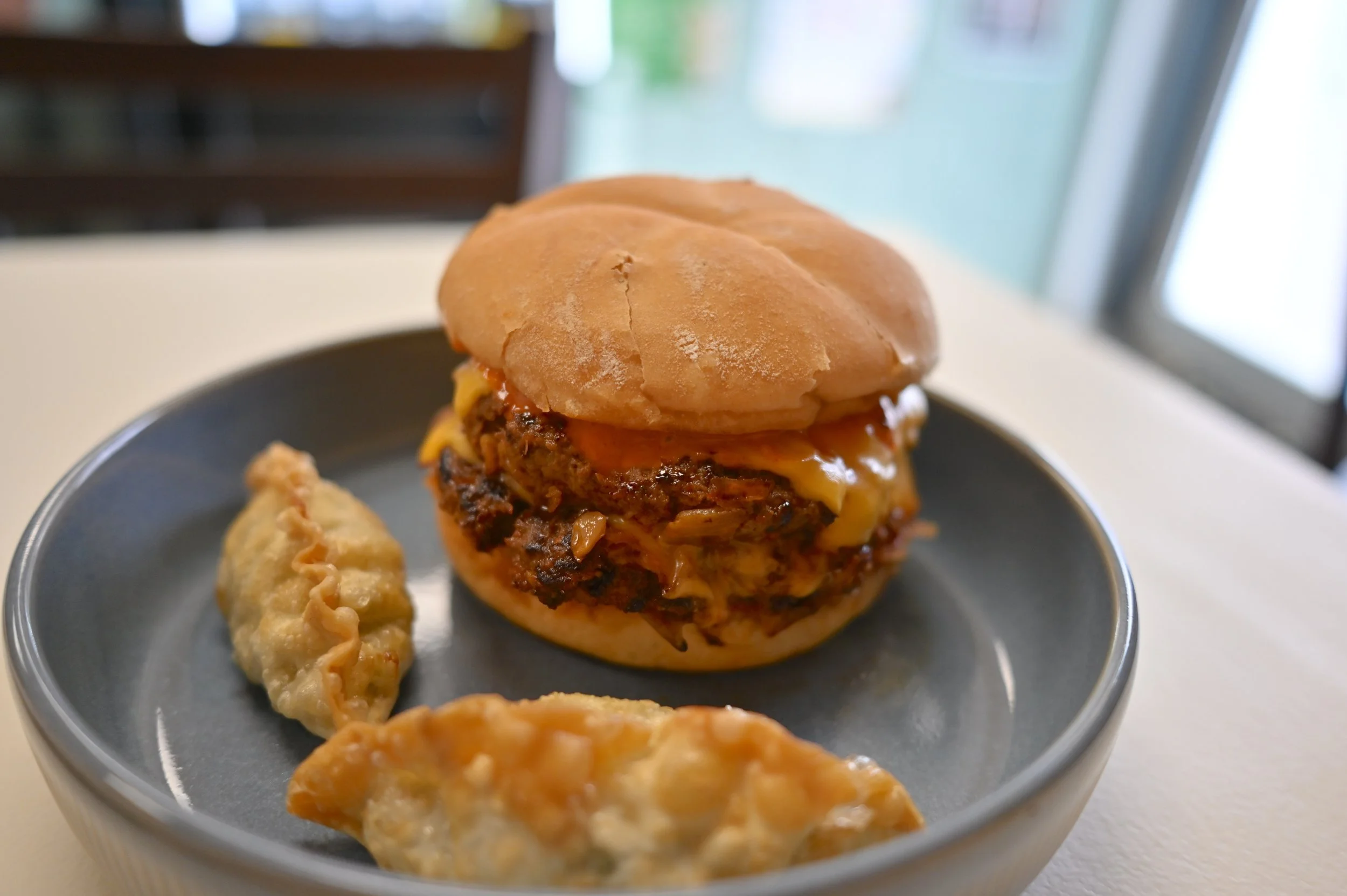 The Kimchi Burger from The Bop Shop served alongside two pork mandu.