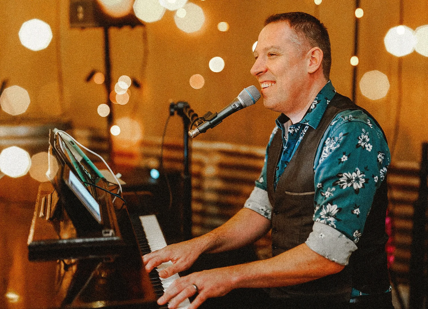 Rohan Windle at the piano in Bar Bamford under warm lights