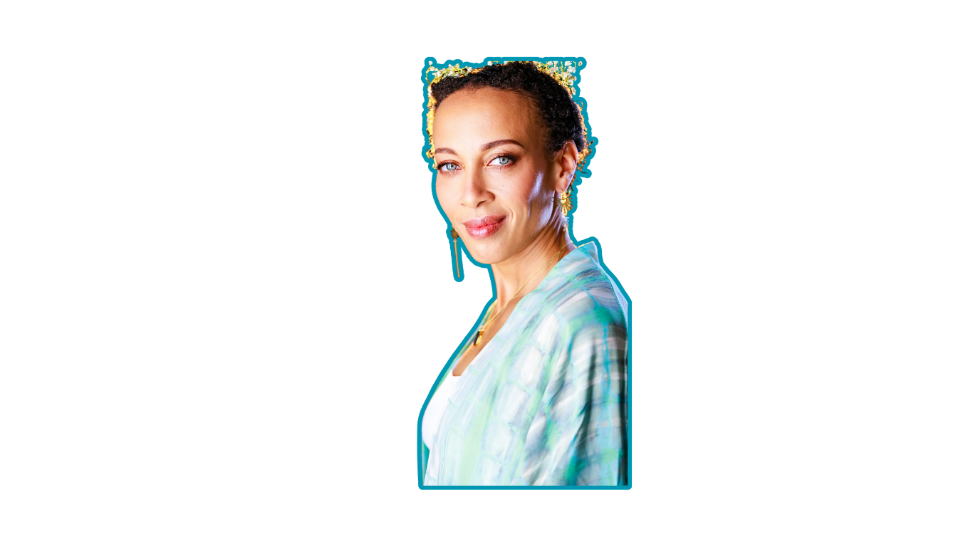 A woman with curly hair and blue eyes, wearing a light-colored patterned blouse, smiling at the camera.