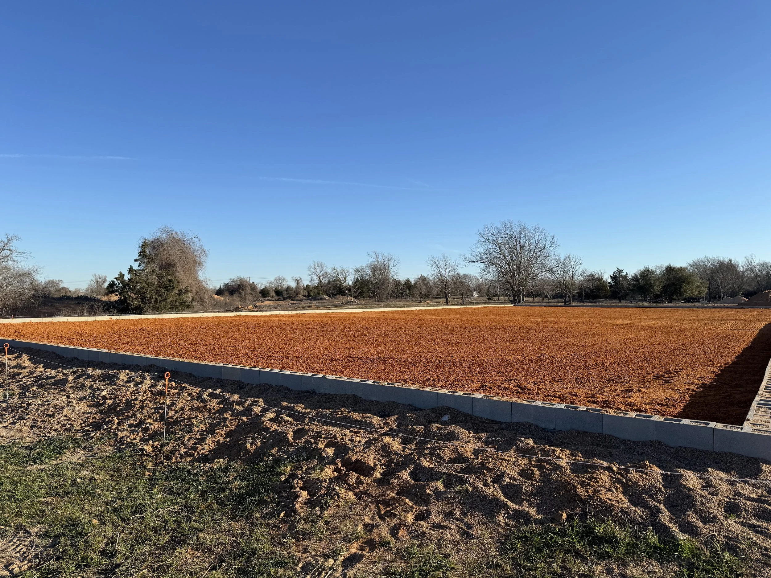 Horse arena constructed with specialized base and footing