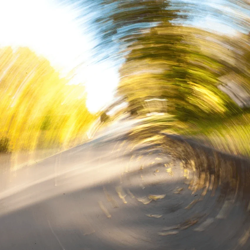 road with trees barely visible due to blurry vision