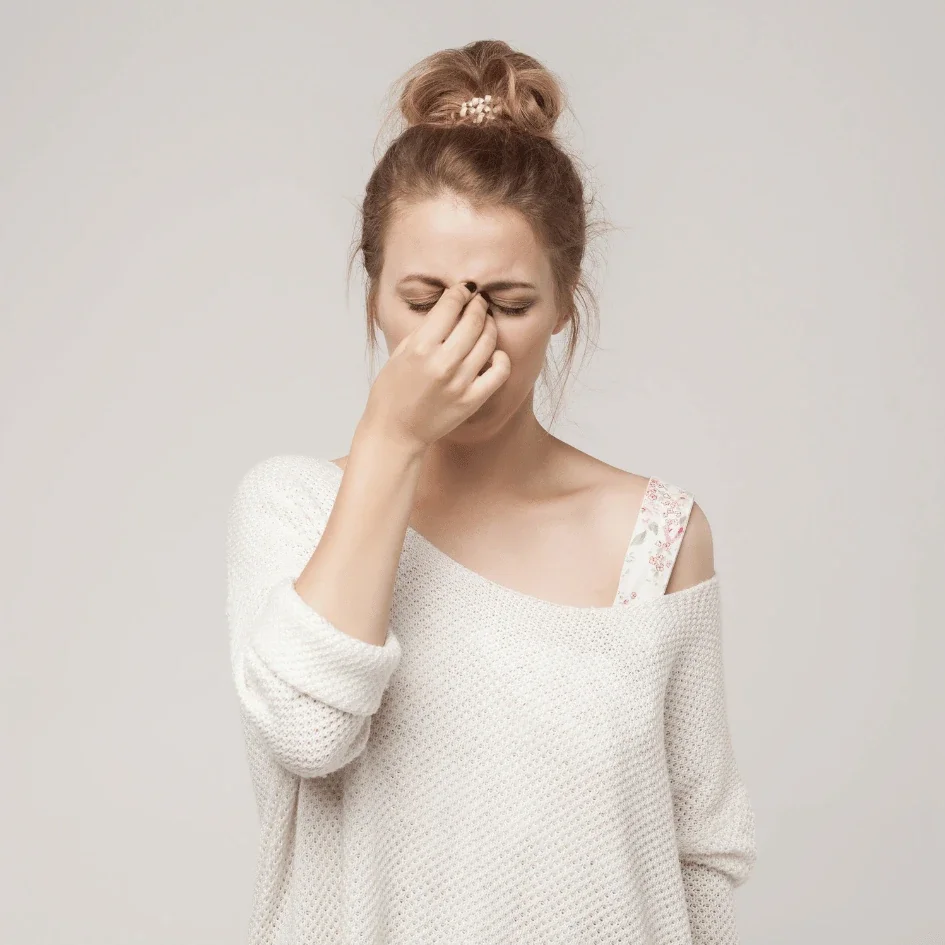 Woman holding her nose due to Dysautonomia