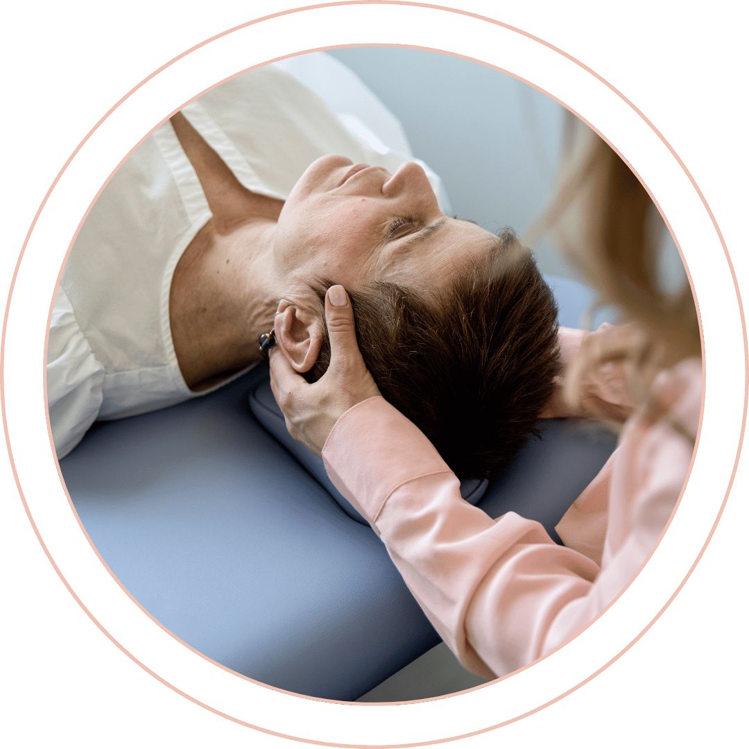 Dr. Rachel Assessing the neck of a female patient laid down on a table
