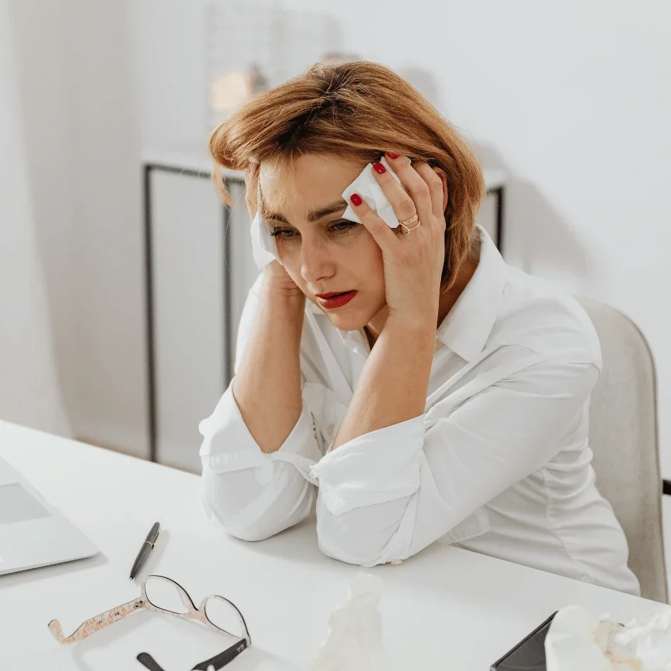 Woman pressing temples due to migraines