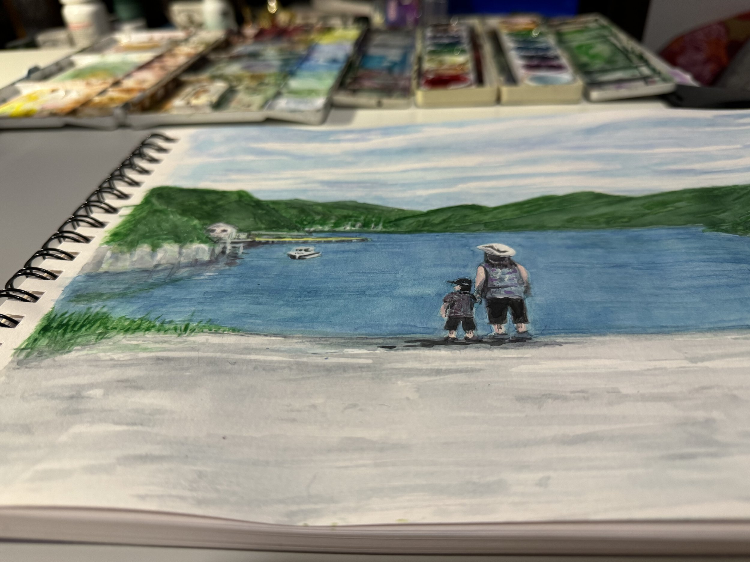 A watercolor painting of a woman and a child standing at the edge of a lake, with hills and greenery in the background, and boats floating on the water.