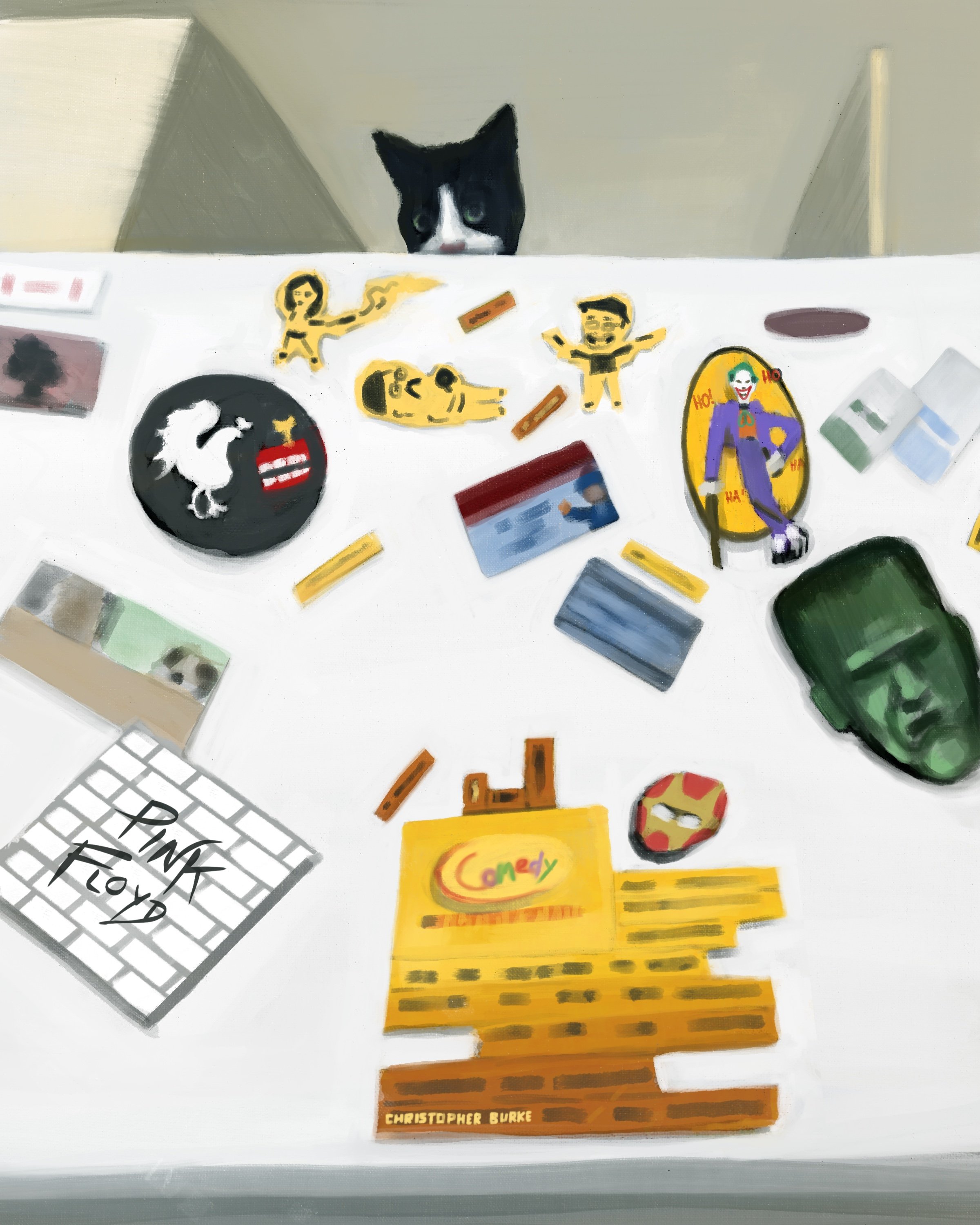 A black and white cat peeking over a table covered with various colorful stickers, cards, and a notepad that says 'PINK TOY'.