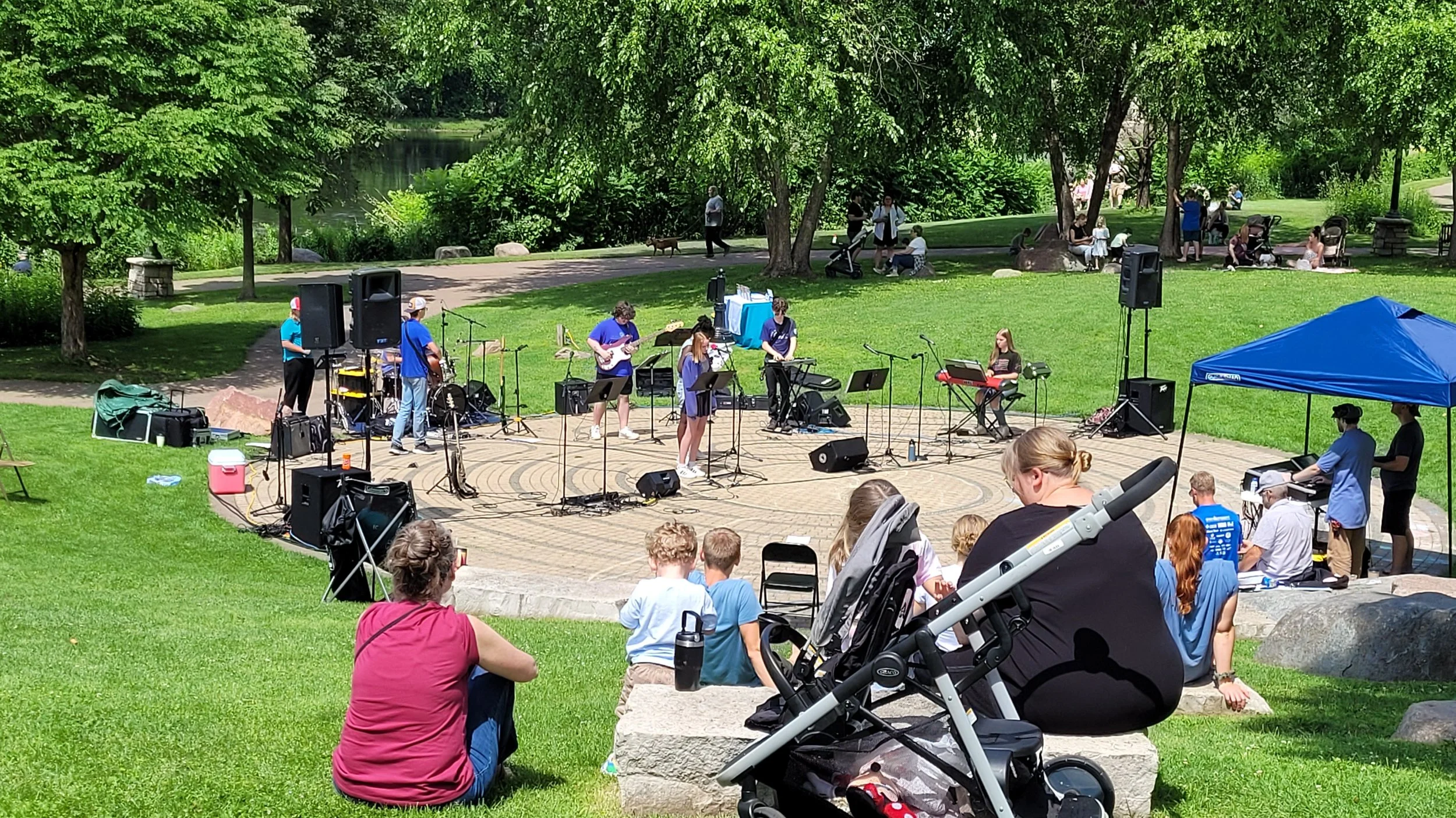 Collective Jam teen students playing modern music at phoenix park in eau claire wi after collective choir gospel and hip hop group in July at the artist market. This takes place July 25th, along with Eaux Claires music festival with Justin Vernon.