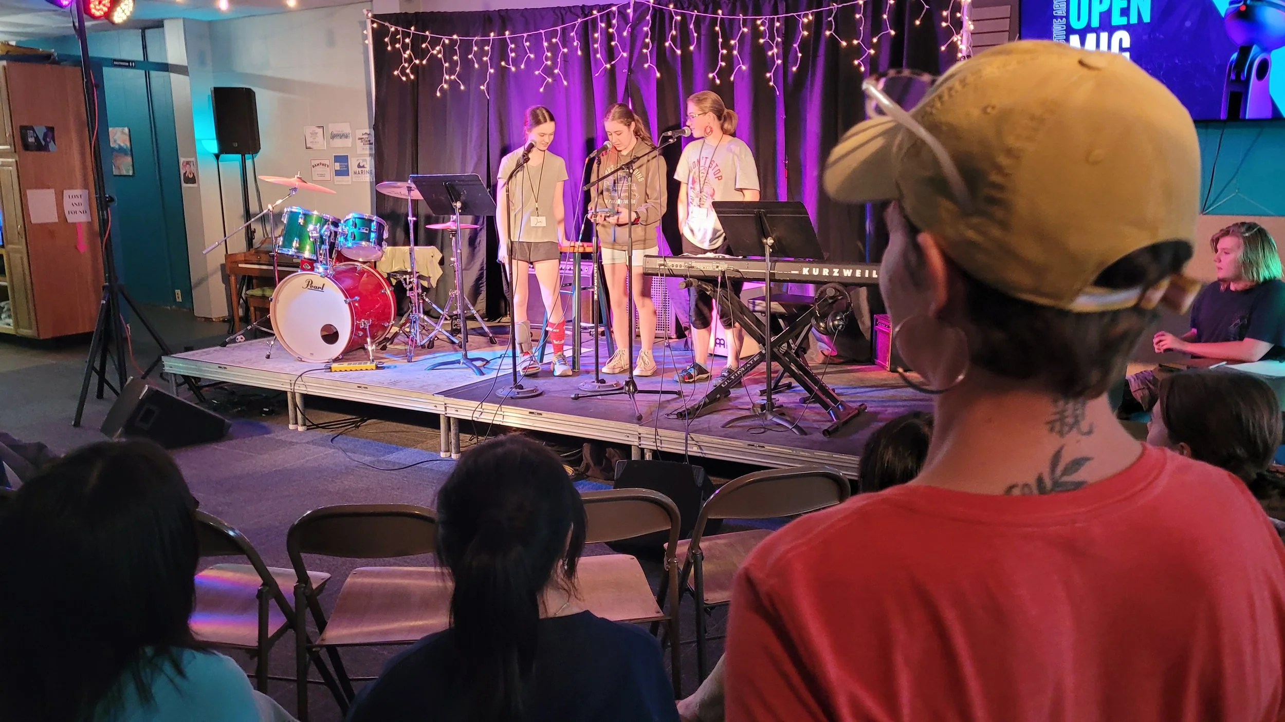 Students singing karaoke at all ages open mic at CollECtive Arts Center, Eau Claire, WI, Jesus CollECtive Jam