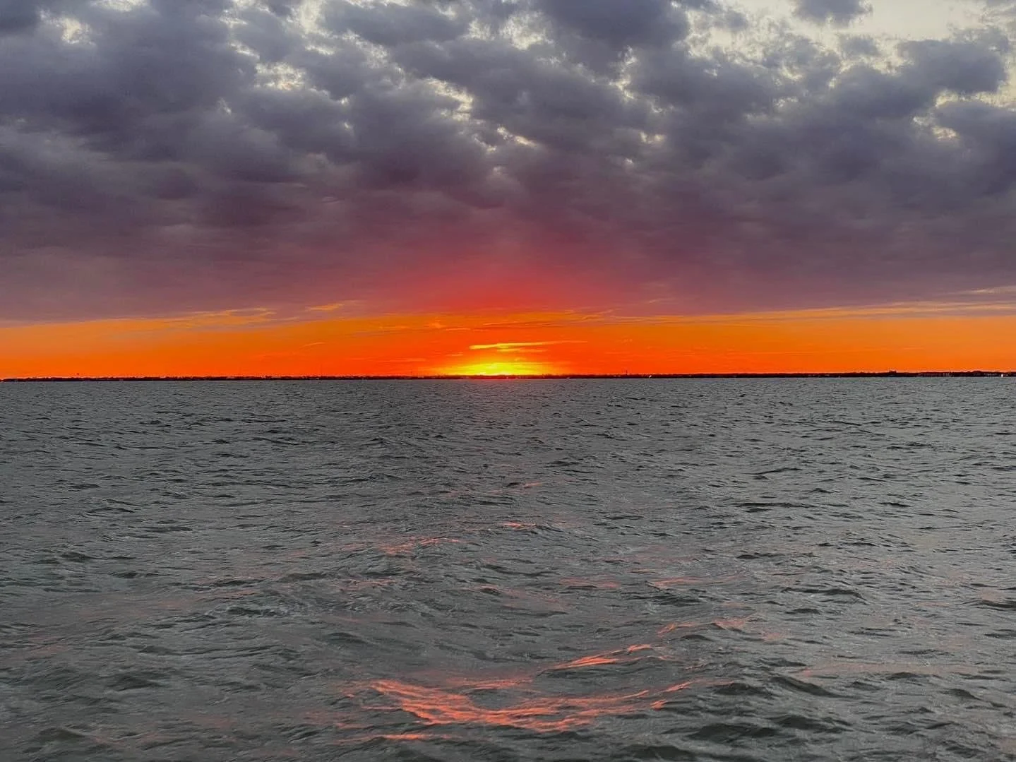 Sun rising over the bay in Fulton Texas at Duck Blind Coffee. 
