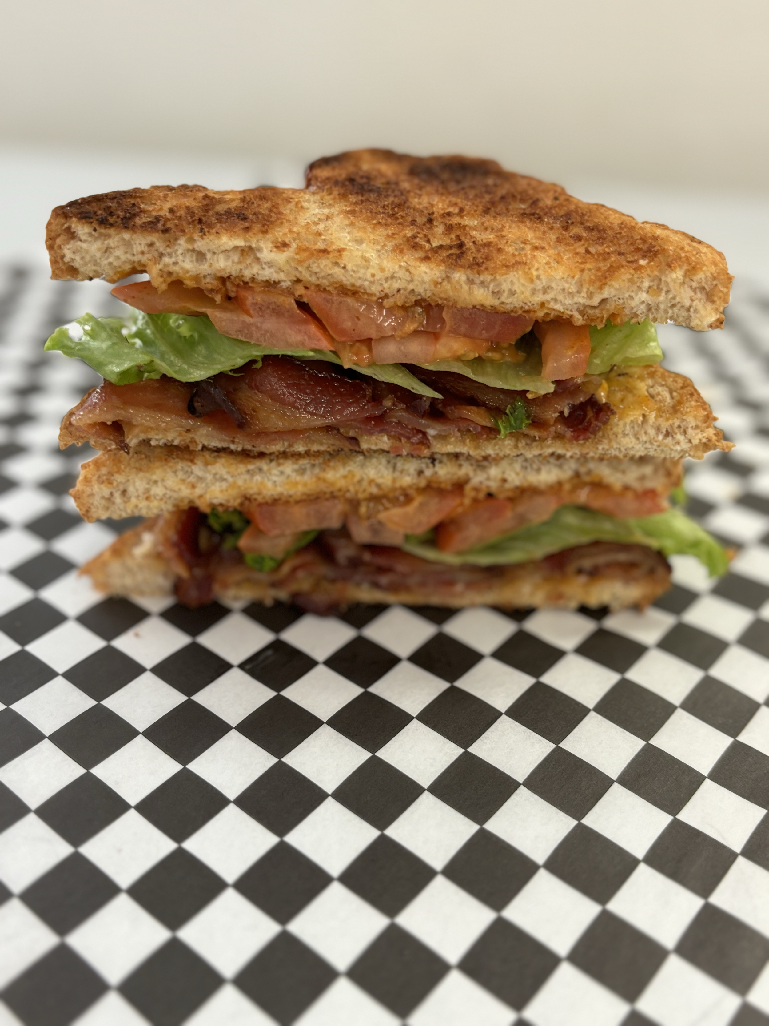 Blue Wing BLT : bacon, lettuce and tomato with chipolte mayo on Honey Wheat bread.