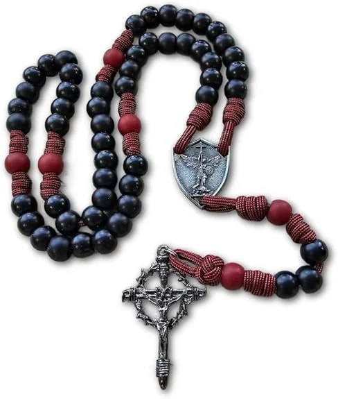 Black and red beaded rosary with a metal crucifix and a medal featuring an image of the Virgin Mary.