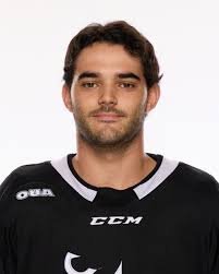 Hockey player in black CCM jersey against white background